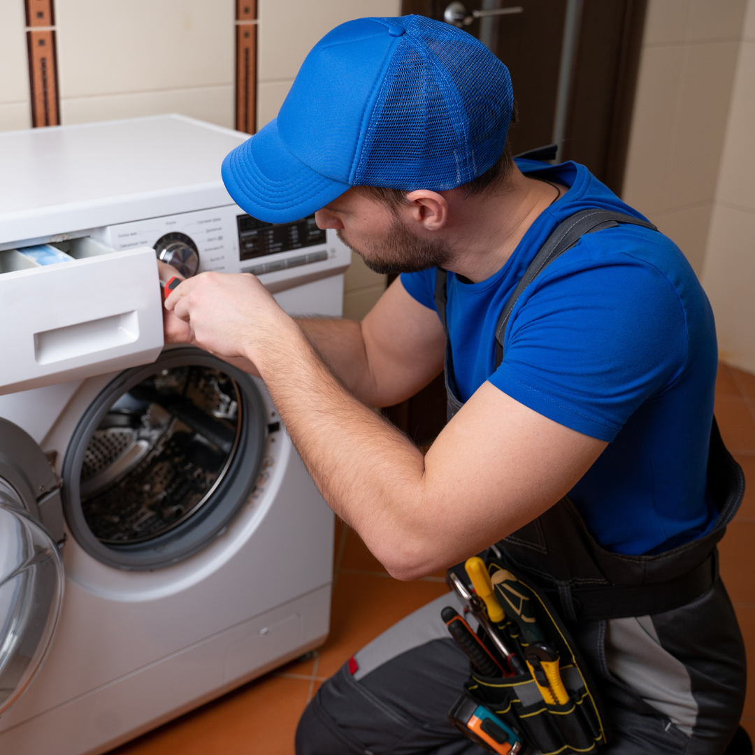 Technician repairing a washing machine