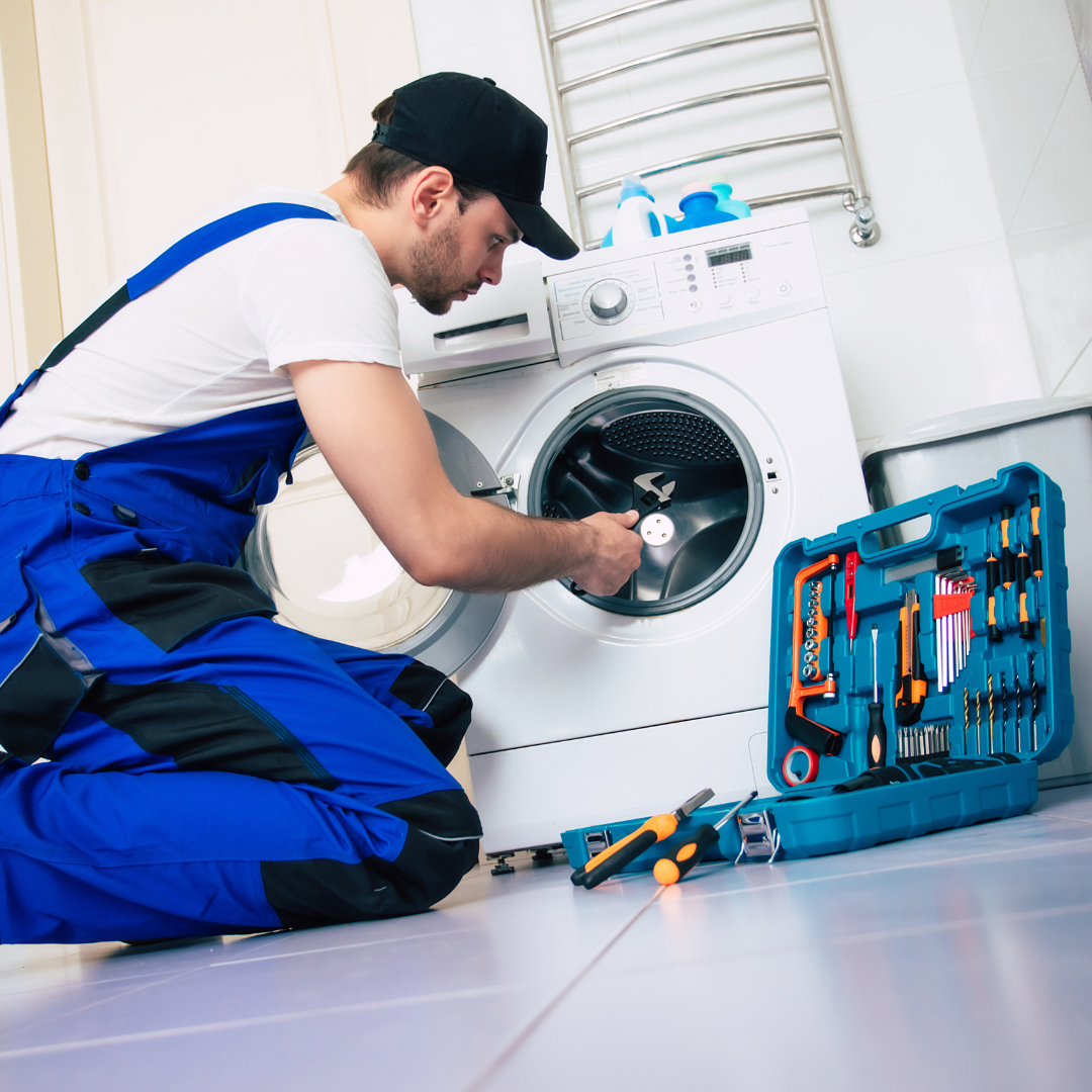 Technician repairing a front-load laundry machine
