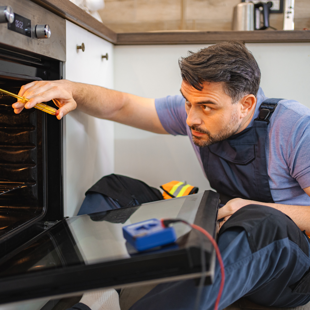 Technician testing an oven with a meter